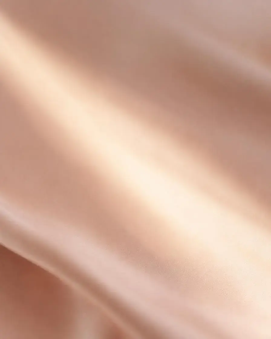 Soft beam of light across blush satin